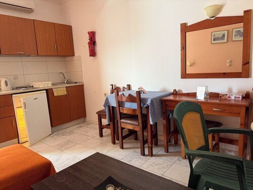 Dining table and equipped kitchenette