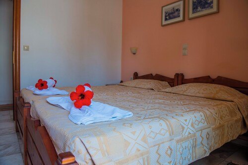 Fresh towels and flowers prepared on the bed