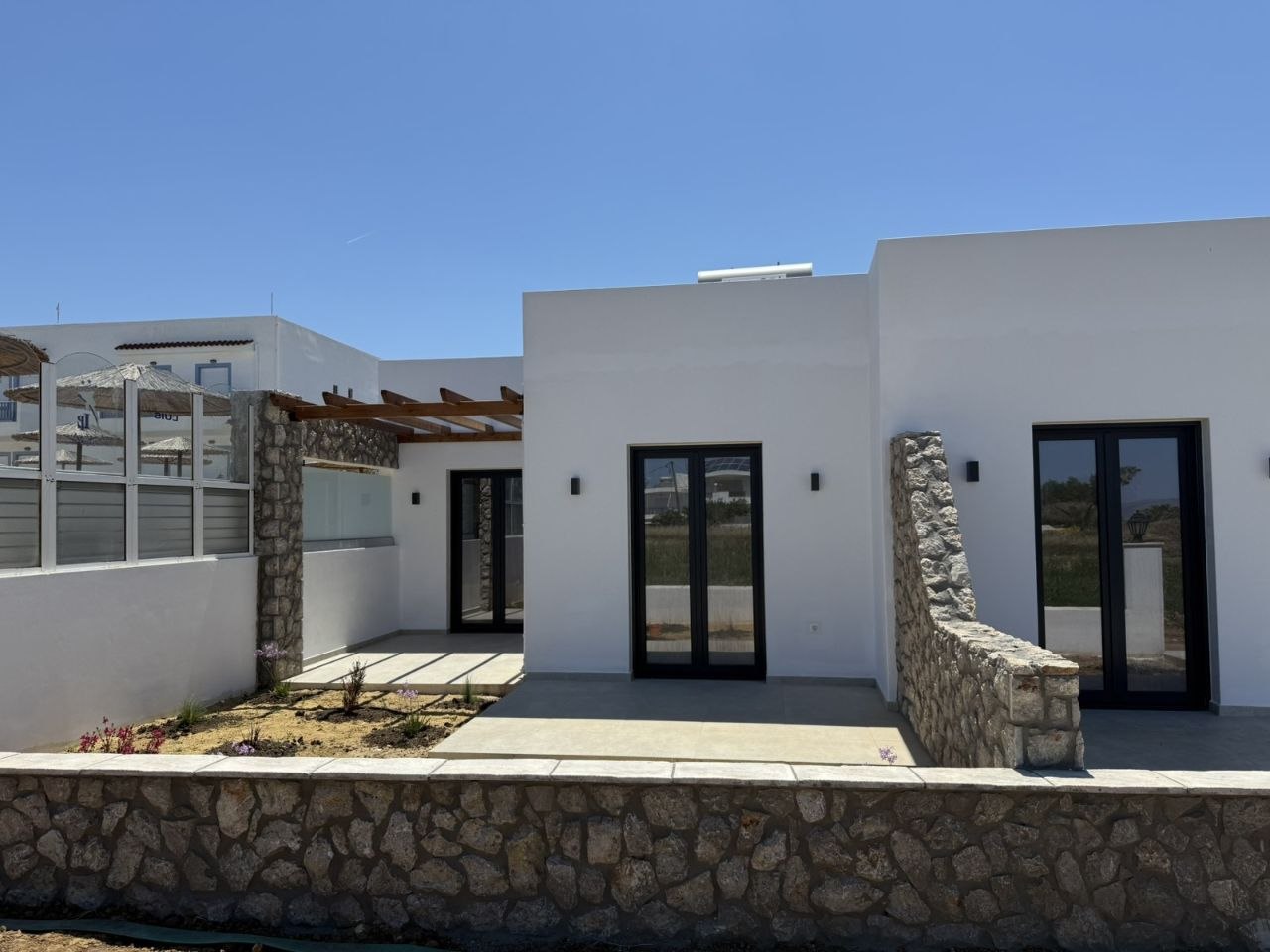 Whitewashed Luis Pool Houses with stone details